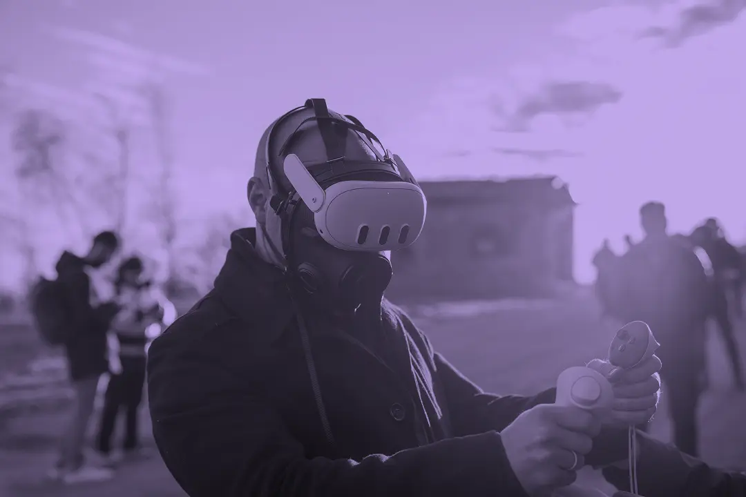Operator wearing Almost Real CBRN mask and VR headset during an outdoor XR training exercise